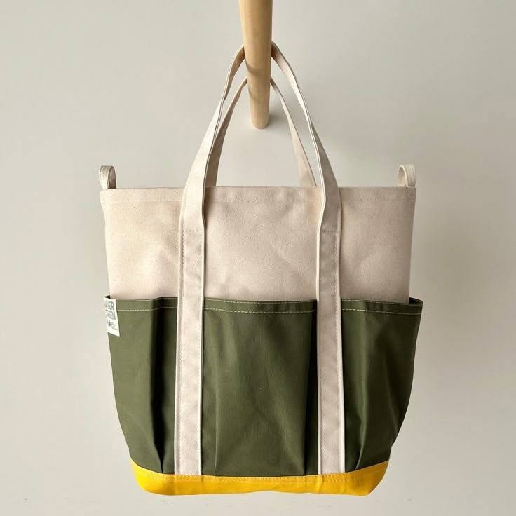 Cream, olive and yellow canvas tote bag with exterior pockets